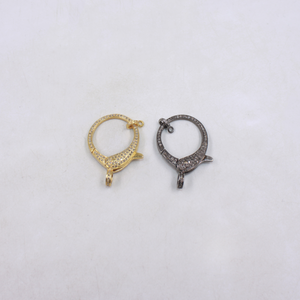 Two gold and silver hoop earrings on a light gray background