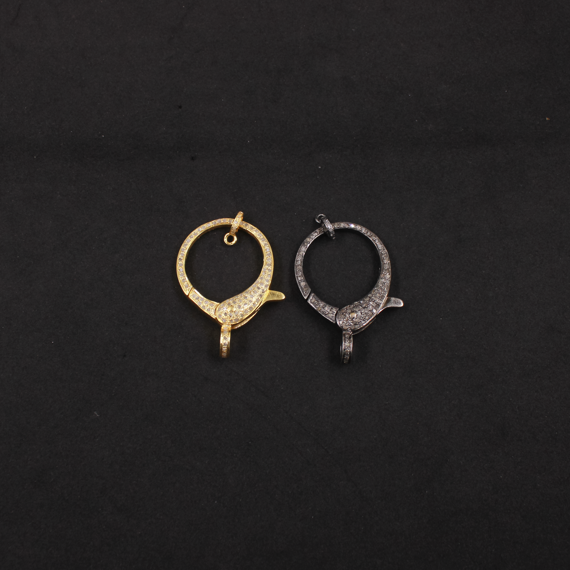 Gold and silver hoop earrings on a black background