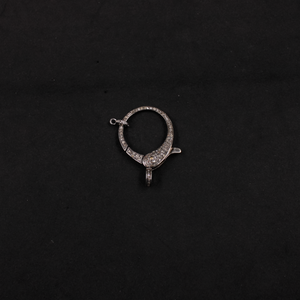 Silver earring on a black background