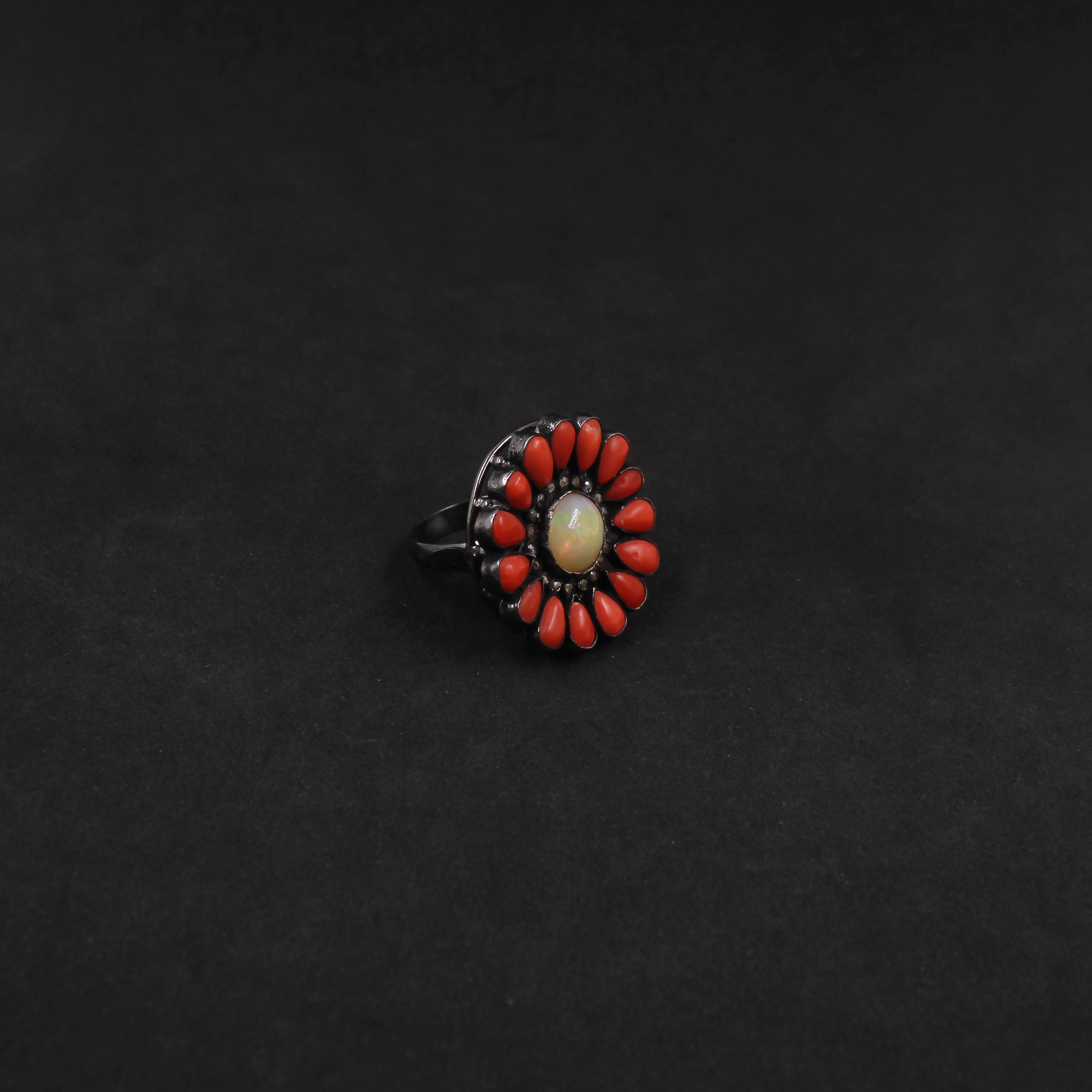 Bold gemstone ring featuring Opal center, Coral petals, and pave diamonds