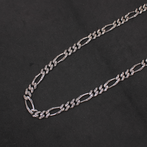 Silver chain necklace on a black background