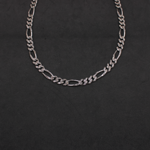 Silver chain necklace on a black background