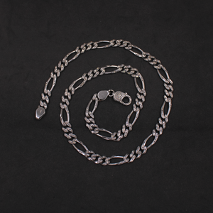 Silver chain necklace on a black background