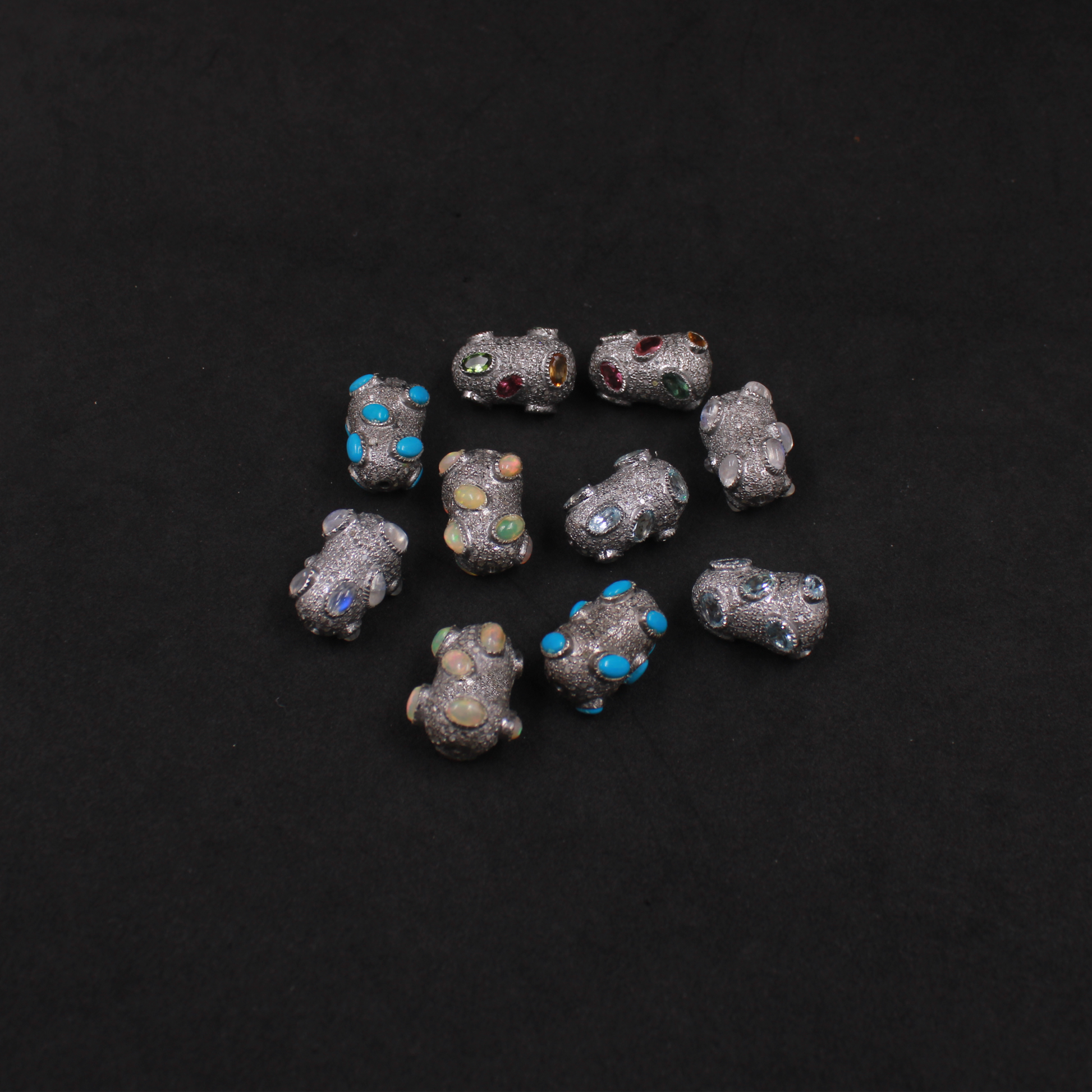 Handcrafted sterling silver beads with natural gemstones and pave diamond details.