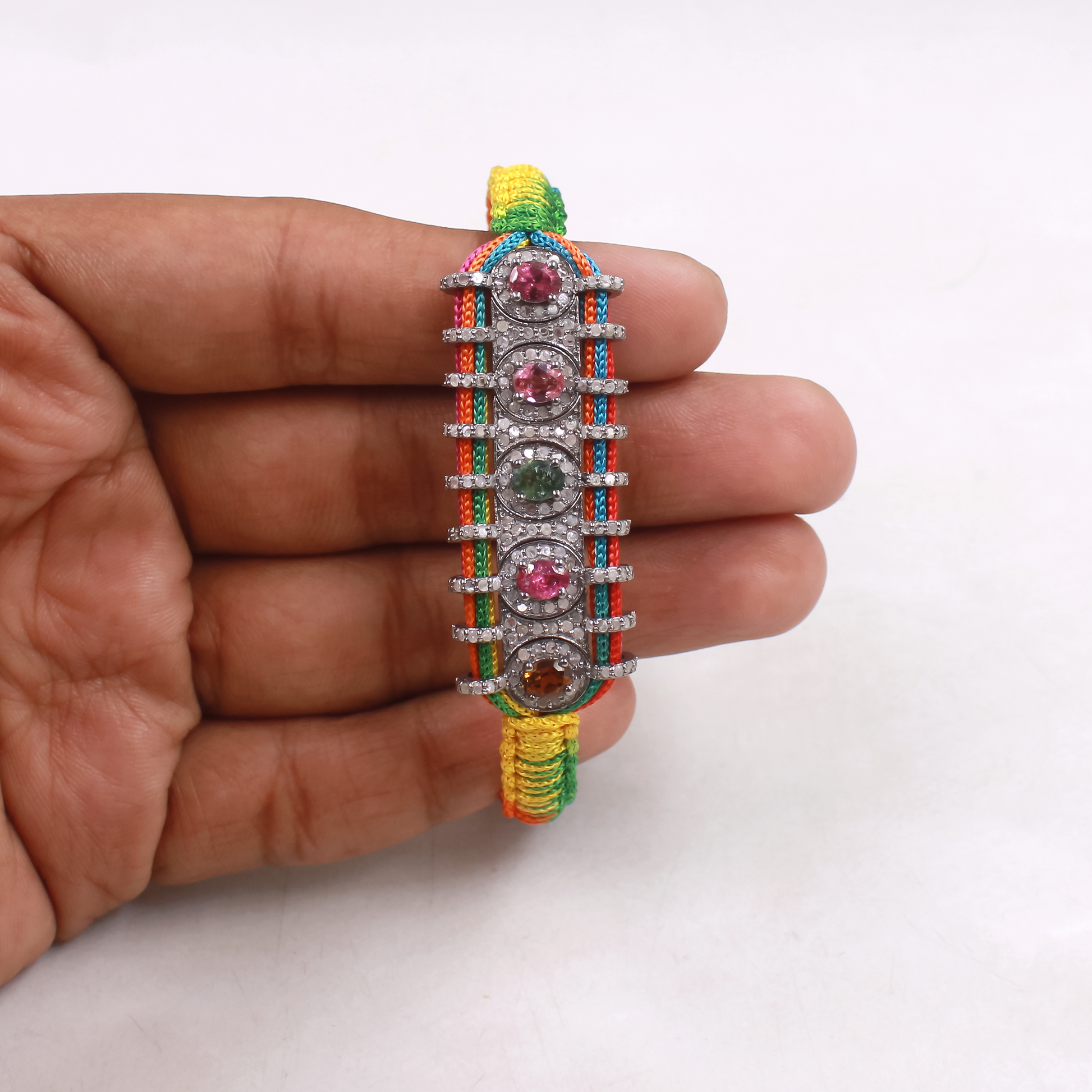 Multi-color tourmaline and diamond bracelet with woven thread design