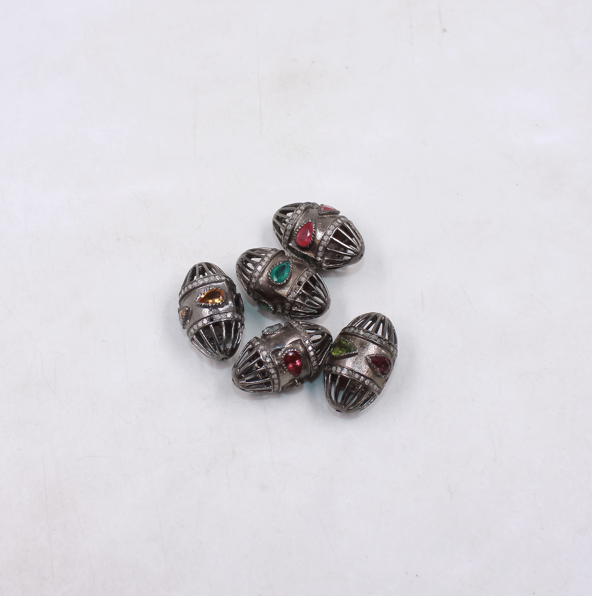 Oval cage style bead with emerald and pave diamonds in sterling silver