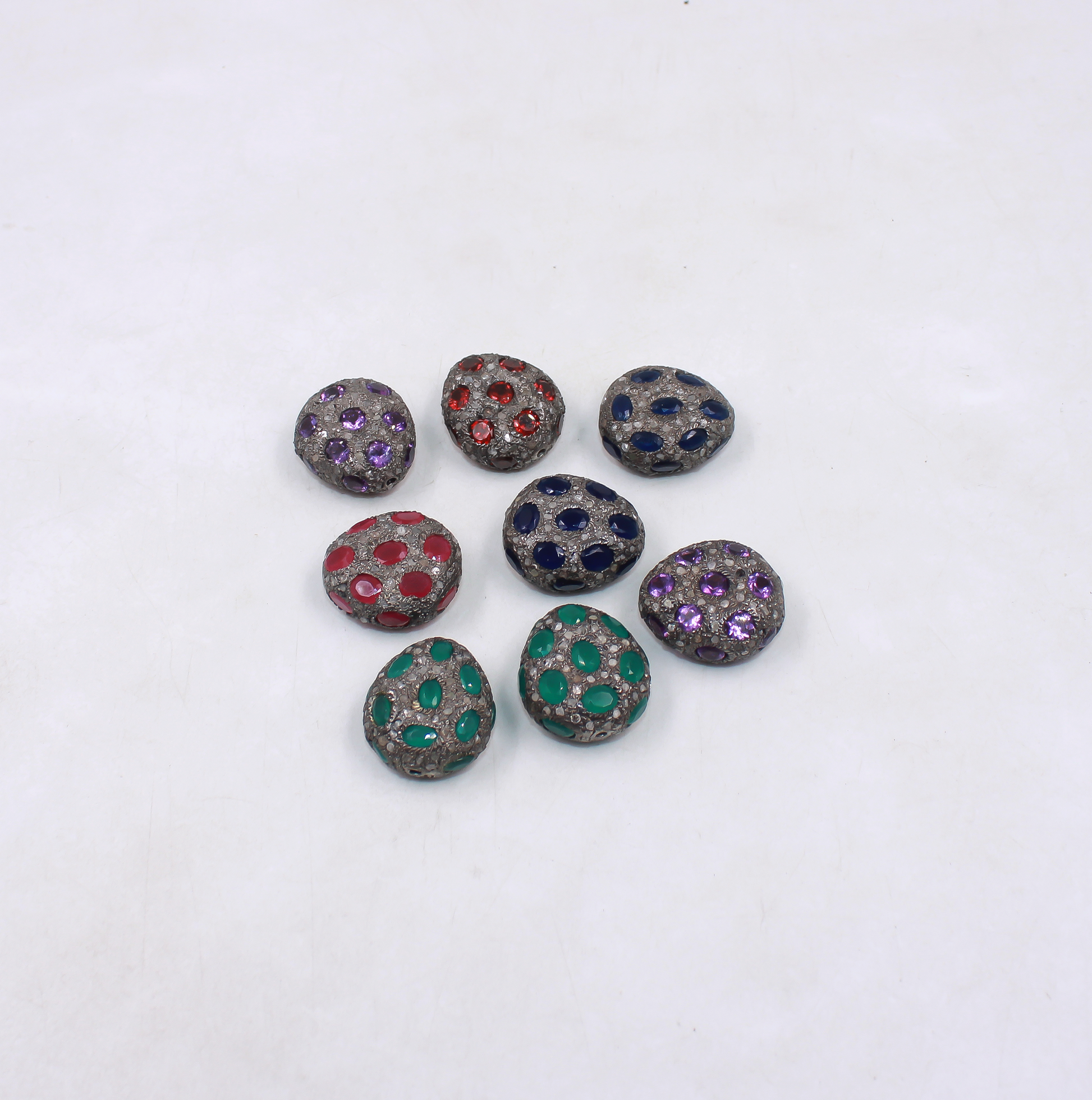 Set of beads with gemstone-like embellishments on a white background