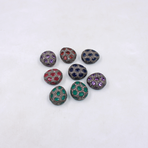 Set of beads with gemstone-like embellishments on a white background