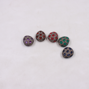 Five decorative buttons with colored gemstones on a white background