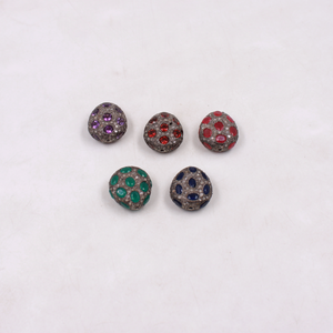 Five round jewelry pieces with colored gemstones on a white background