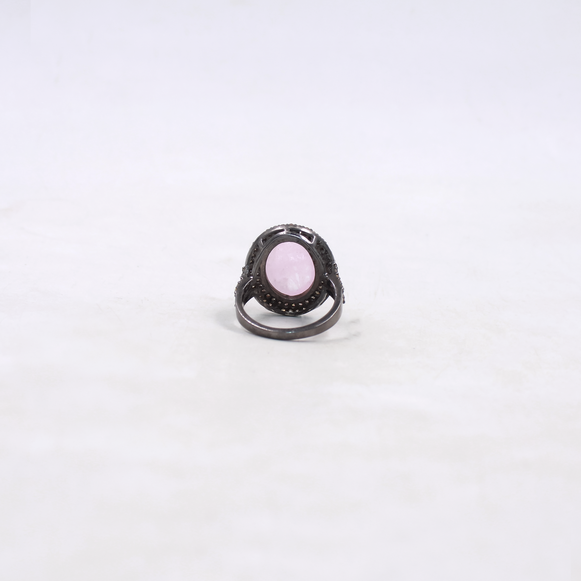 Ring with a pink gemstone on a white background