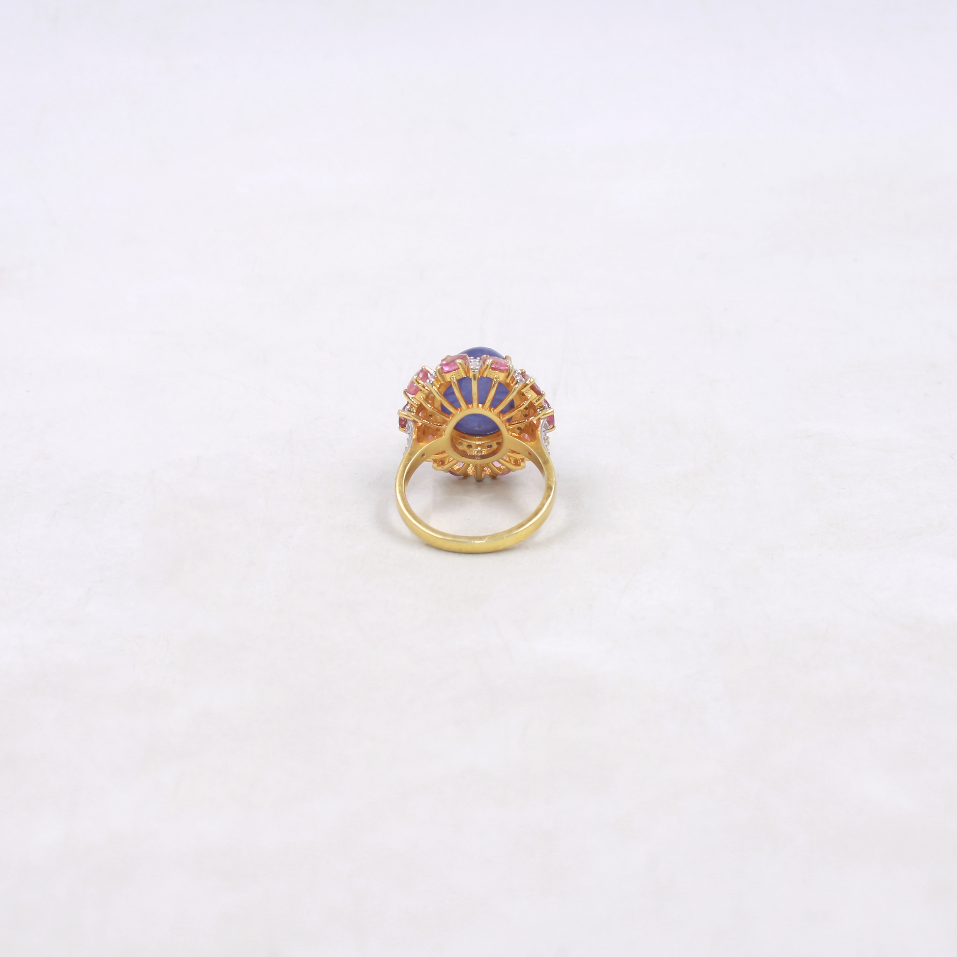 Gold ring with gemstones on a white background