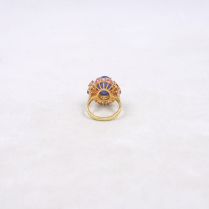 Gold ring with gemstones on a white background