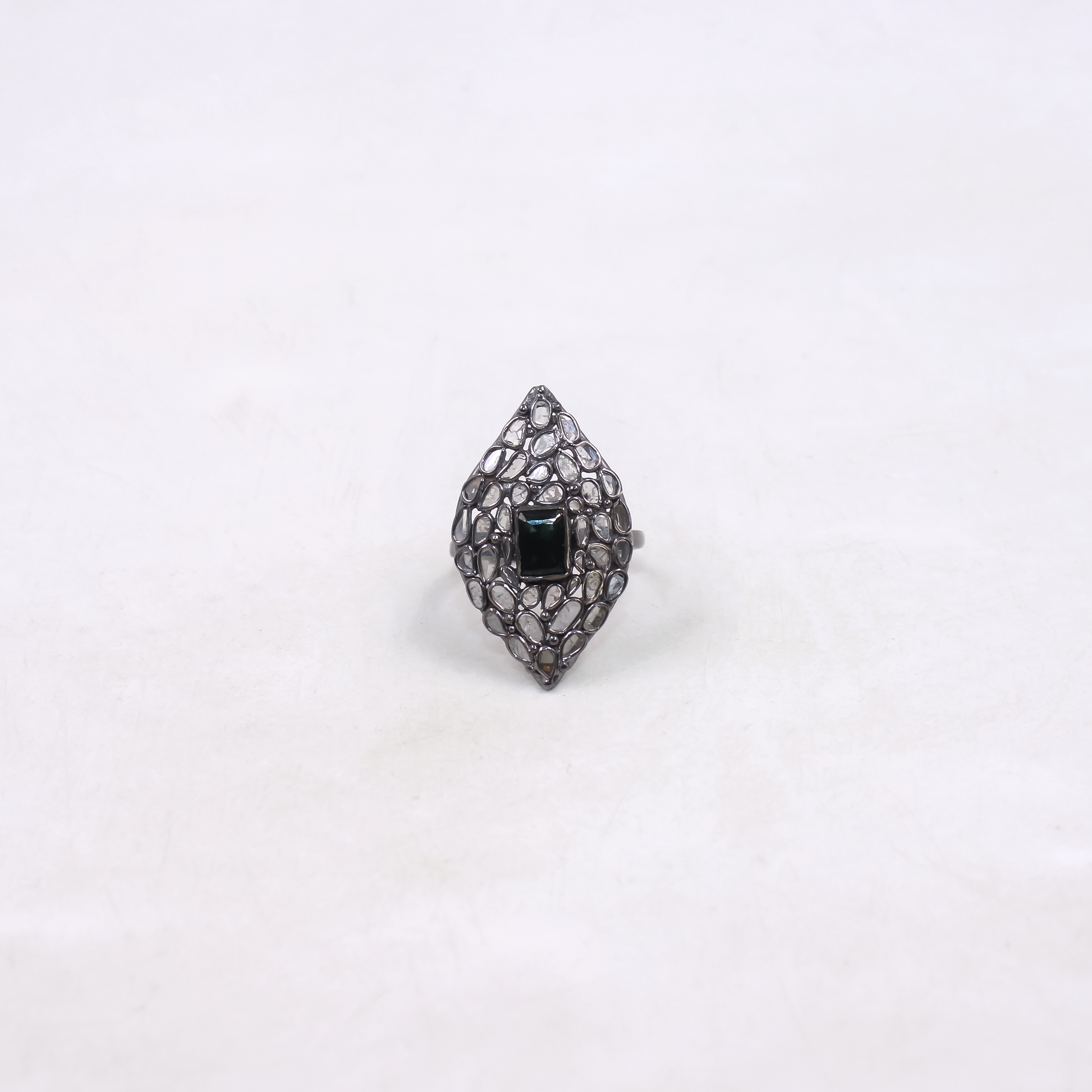 Ring with black gemstone and intricate design on a white background