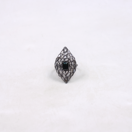 Ring with black gemstone and intricate design on a white background