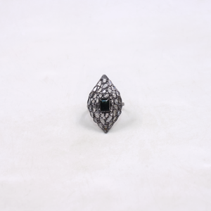 Ring with black gemstone and intricate design on a white background