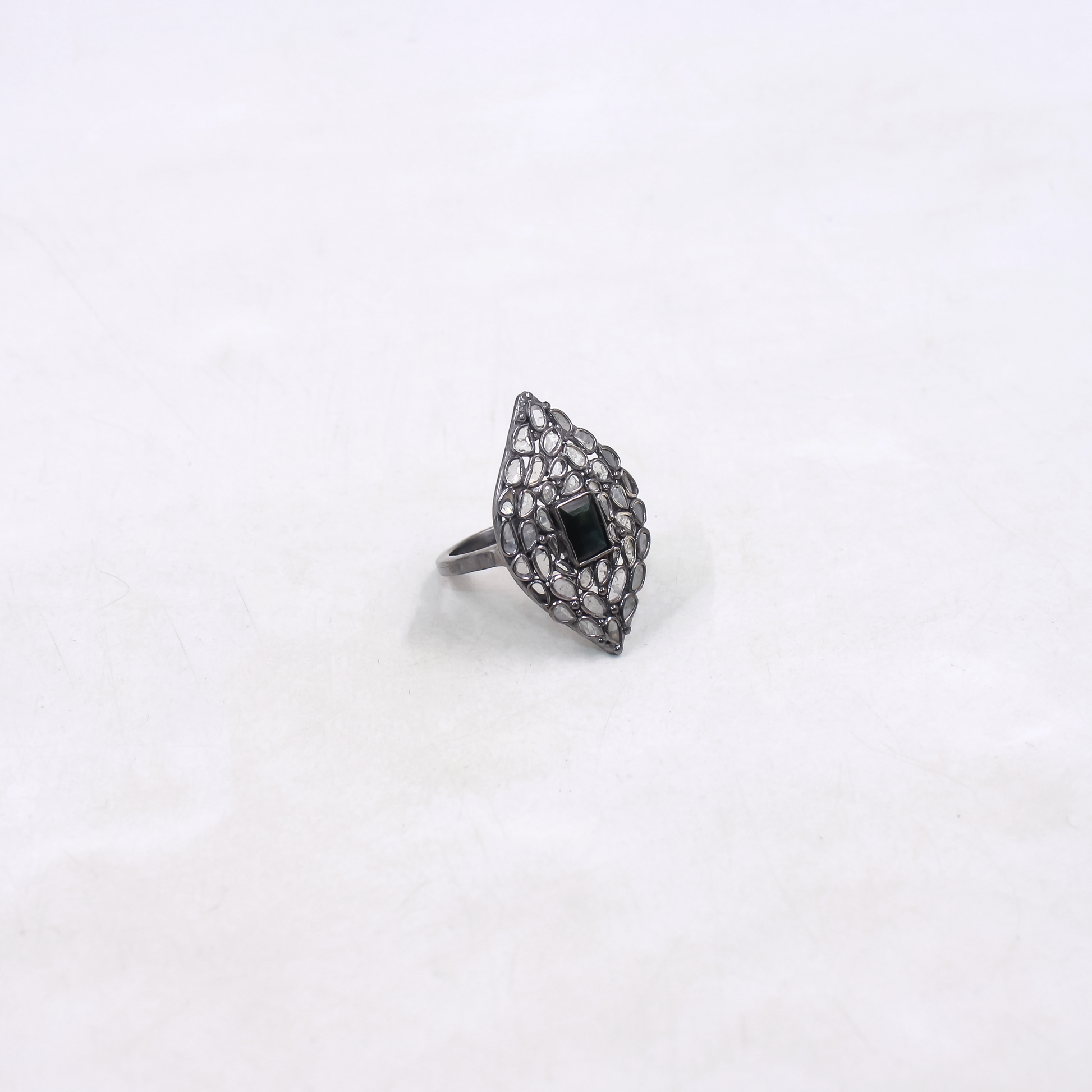 Silver ring with a black gemstone on a white background
