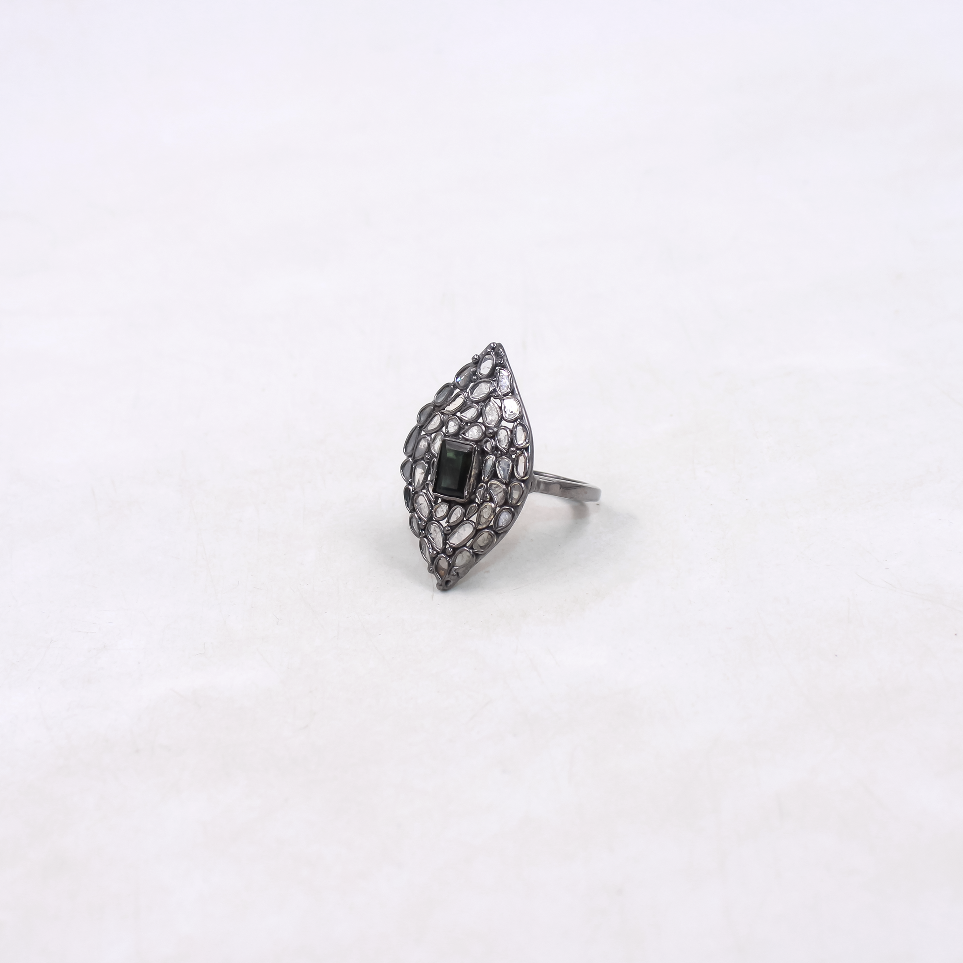 Silver ring with black gemstone on a white background