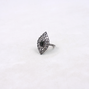 Silver ring with black gemstone on a white background