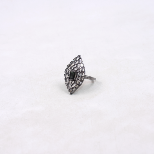 Silver ring with black gemstone on a white background