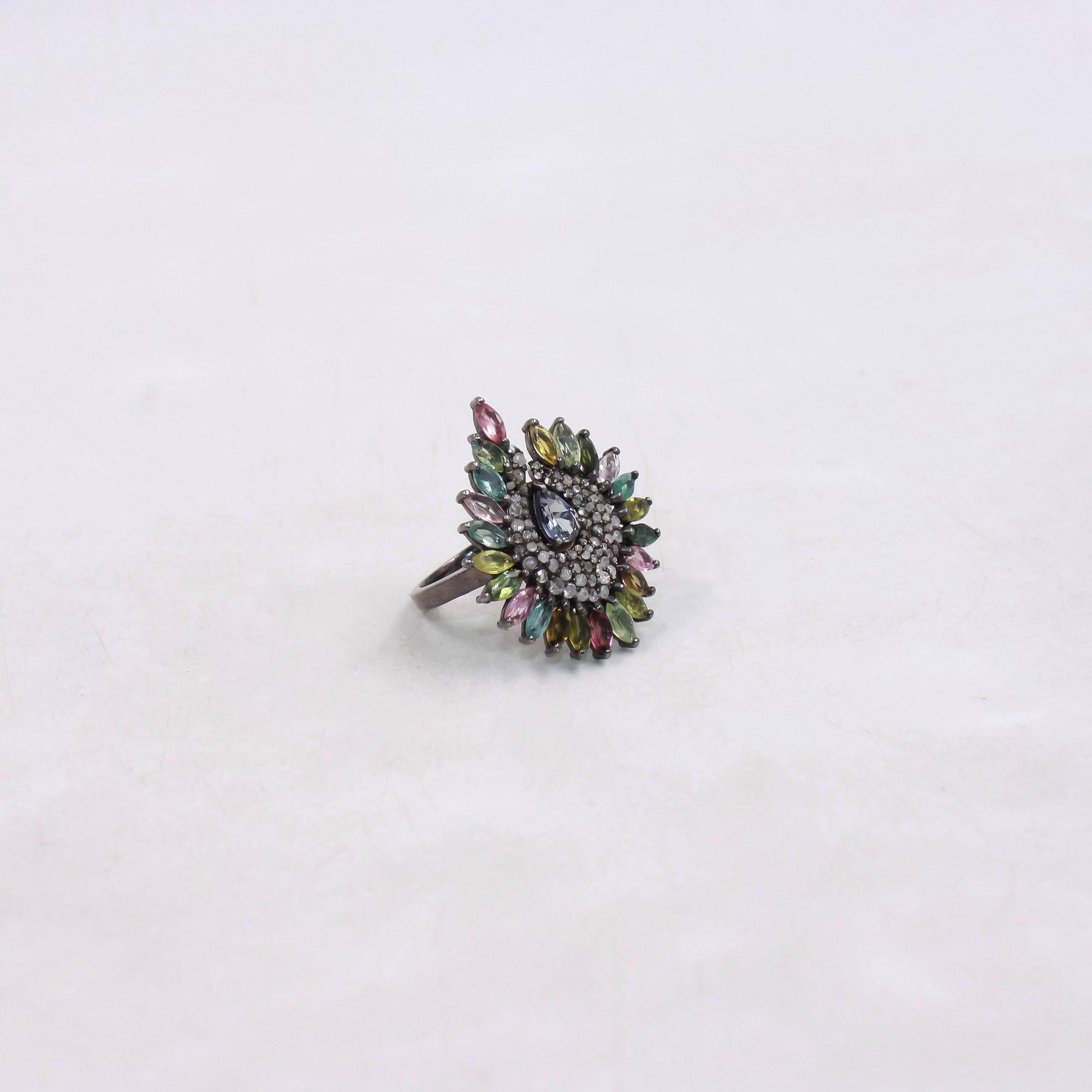 Multicolored gemstone ring on a white background