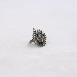 Multicolored gemstone ring on a white background