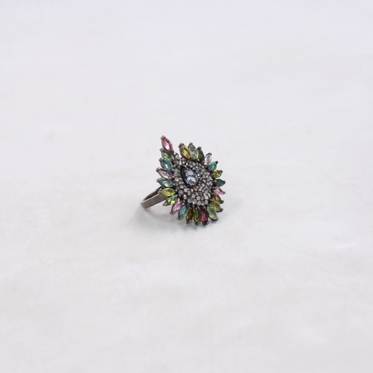Multicolored gemstone ring on a white background