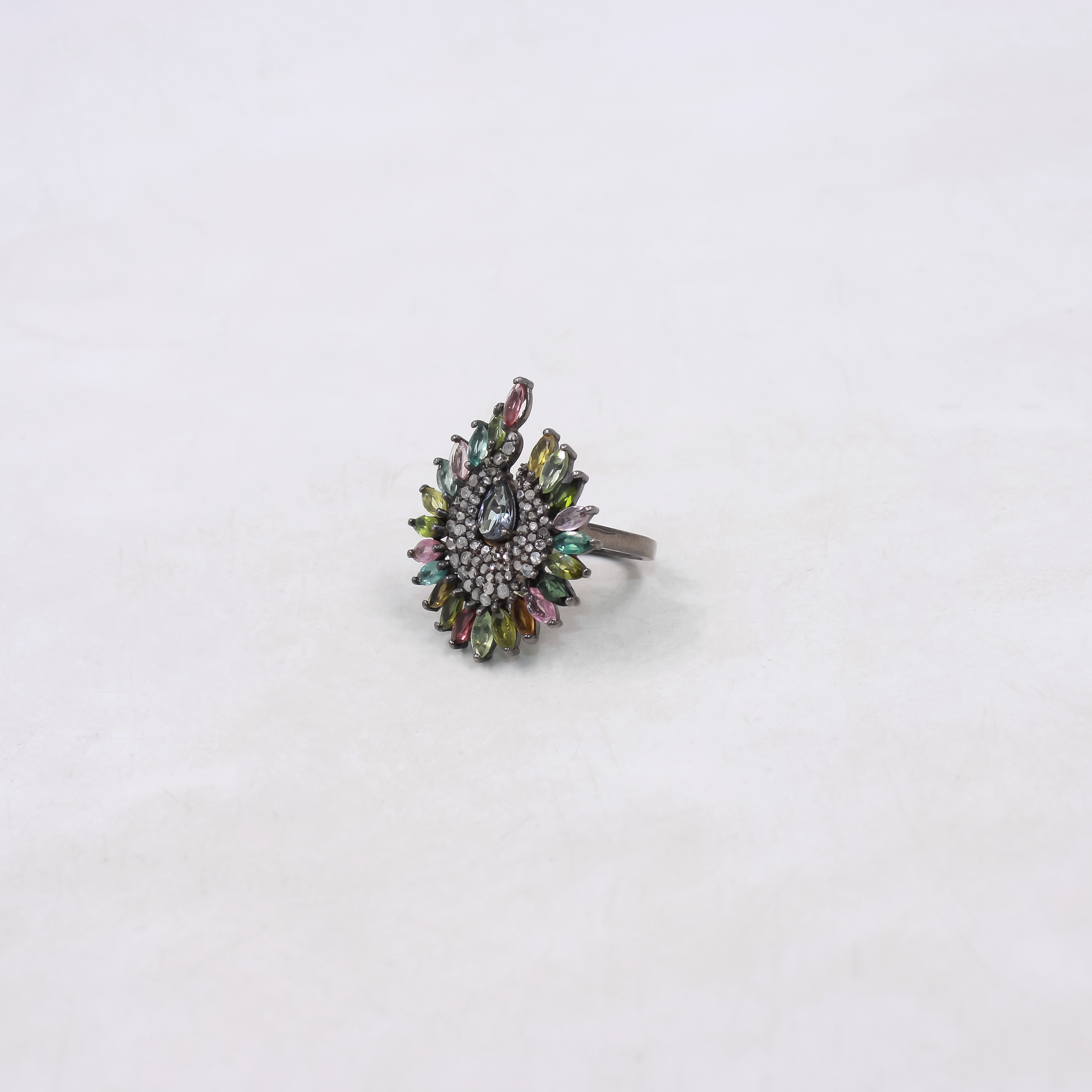 Multicolored gemstone ring on a white background