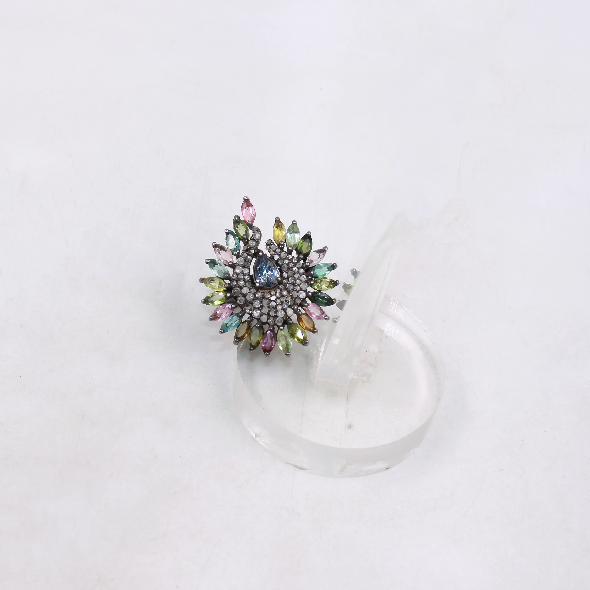 Multicolored gemstone ring on a white background