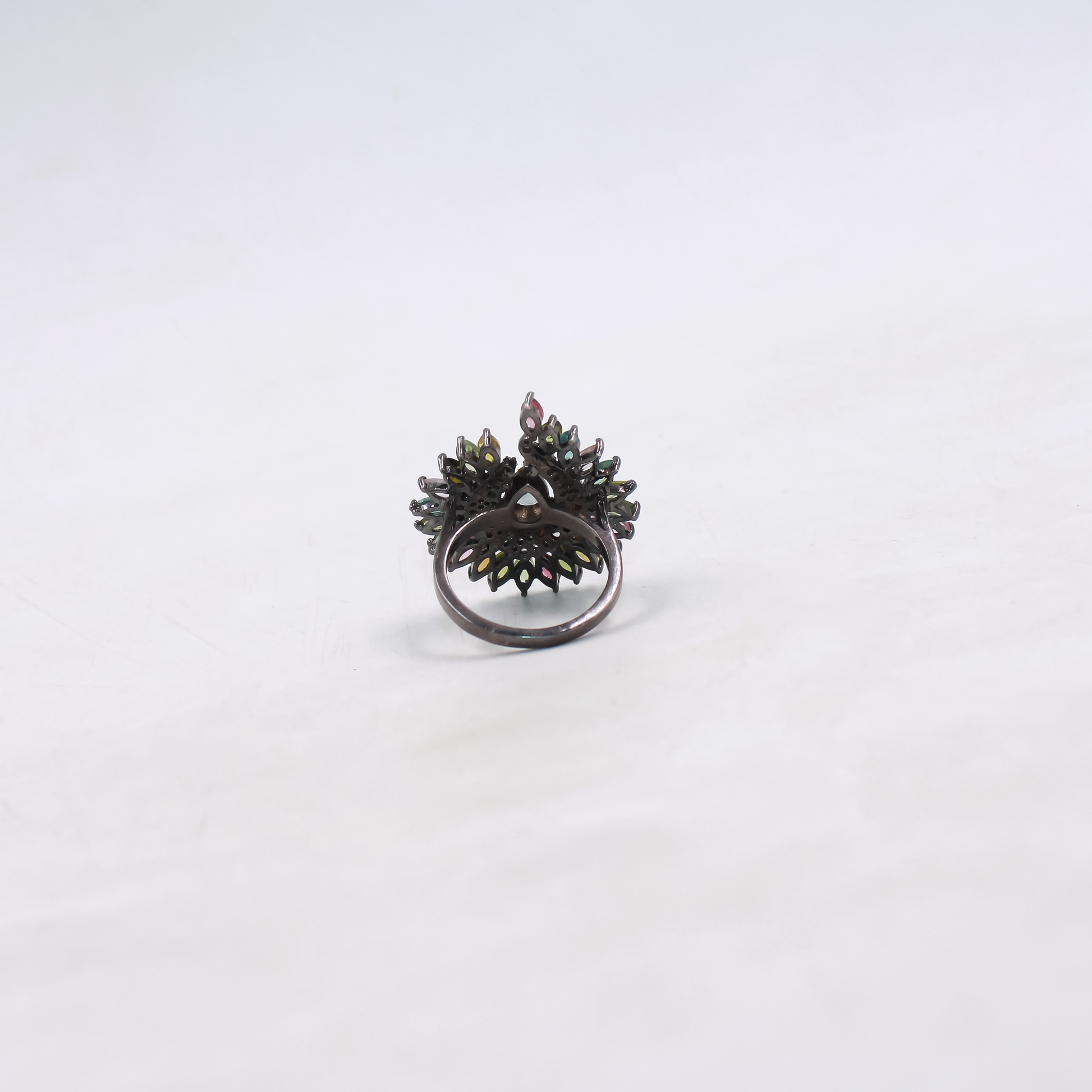 Black ring with floral design on a white background