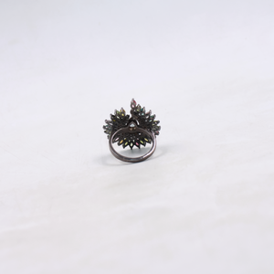 Black ring with floral design on a white background