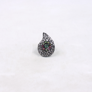 Teardrop-shaped ring with gemstones on a white background