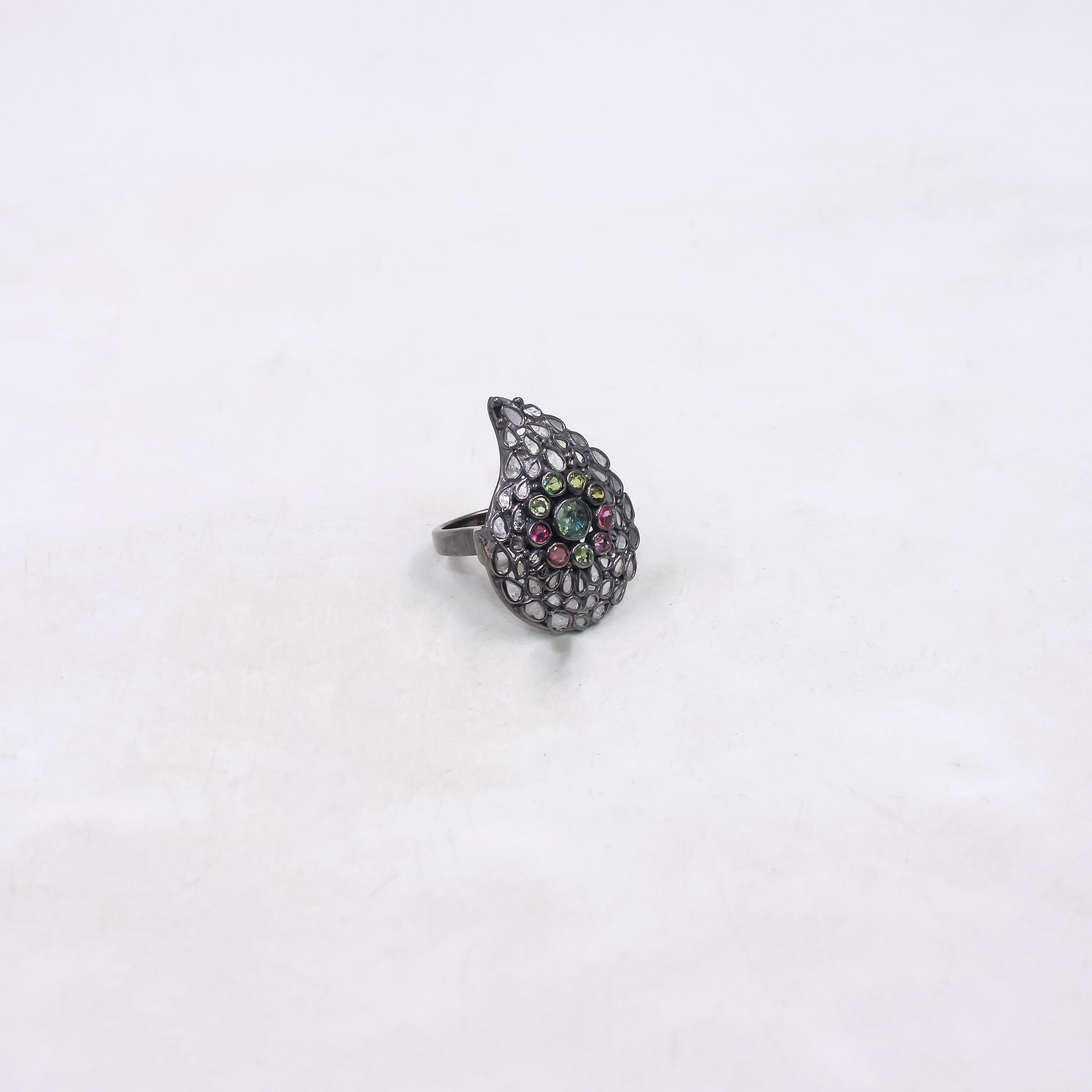 Silver ring with colorful gemstones on a white background