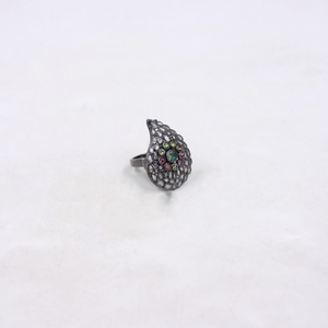 Silver ring with colorful gemstones on a white background