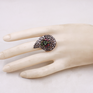 Ring with gemstones on a mannequin hand against a white background