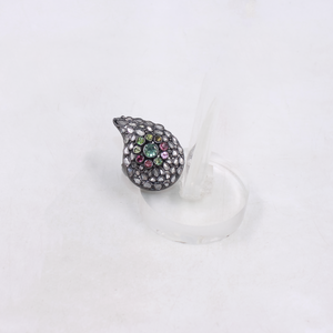 Teardrop-shaped jewelry piece with multicolored stones on a white background