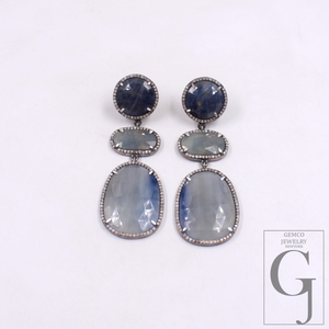 Pair of earrings with Blue Sapphire on a white background, featuring Gemco Jewelry logo.