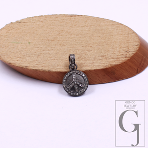 Silver peace sign pendant on a wooden disc with Gemco Jewelry New York logo.