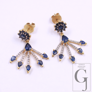 Gold earrings with blue gemstones on a white background, featuring Gemco Jewelry branding.