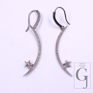 Pair of silver earrings with star designs on a white background, featuring Gemco Jewelry logo.