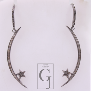 Pair of silver earrings with star designs on a white background, featuring the Gemco Jewelry logo.