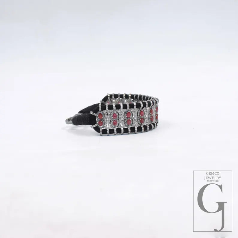 Bracelet with red stones on a white background, featuring the Gemco Jewelry logo.